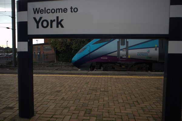 A Transpennine Express Class 802 leaving York Train Station. Photo taken from underneath the "Welcome to York" sign.